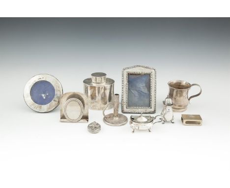 AN ASSORTED COLLECTION OF SILVER ITEMS, including a small christening cup, an oval tea caddy, photograph frames, miniature co