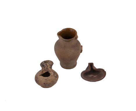 A ROMAN PERIOD CYPRIOT POTTERY OIL LAMP. 7.75cm long; together with a small Roman period oil lamp, with 'pinched' spout. 7cm 