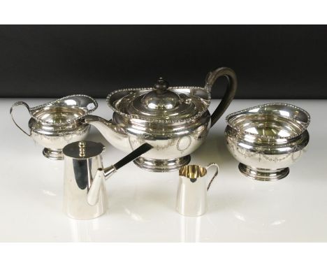 A silver plated Harrods tea set to include tea pot, sugar bowl and cream jug together with an Asprey hot chocolate pot and cr