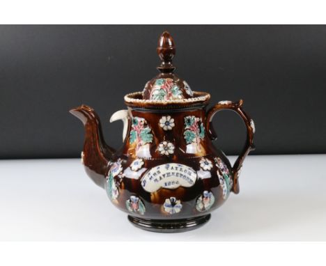 Victorian Bargeware Teapot inscribed ' Mrs Taylor, Ravenstone 1884 ', with applied floral decoration, 30cm high 