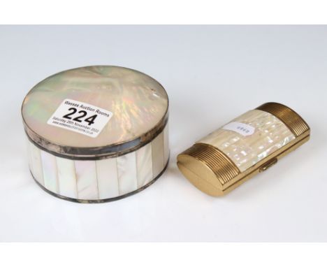 A mother of pearl powder jar with white metal banding together with a similar lipstick holder. 