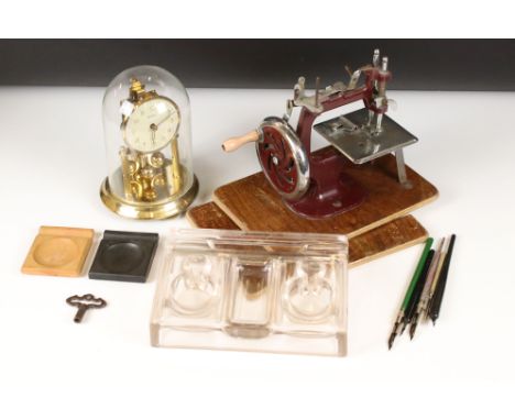 A small box of mixed collectables to include a sewing machine, anniversary clock and a standish. 