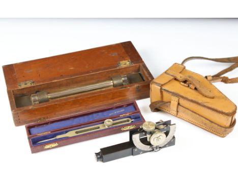 A small group of collectables to include a leather cased Stanley clinometer and a wooden cased brass rolling ruler. 
