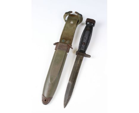 A United State Korean War era M5 bayonet complete with scabbard and frog. 