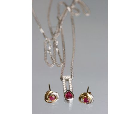 An 18ct white gold and ruby pendant necklace together with matching earrings. 