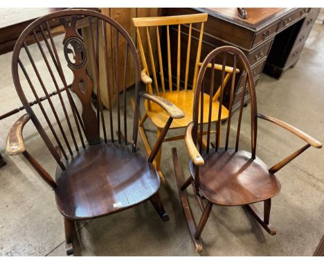 An Ercol Golden Dawn fleur de lis rocking chair, an Ercol Golden Dawn rocking chair and one other