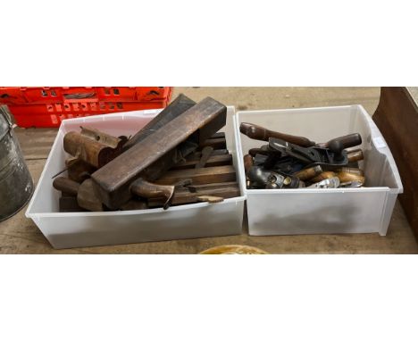 A collection of woodworking tools including 24 chisels, three planes, and a oil stone