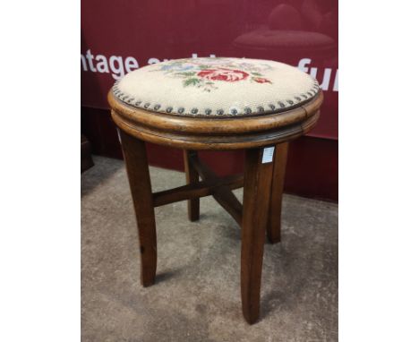 An oak circular stool, with floral tapestry top