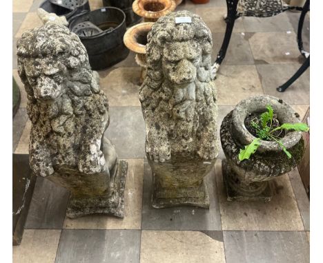 A pair of garden figures of lions and a concrete garden planter 