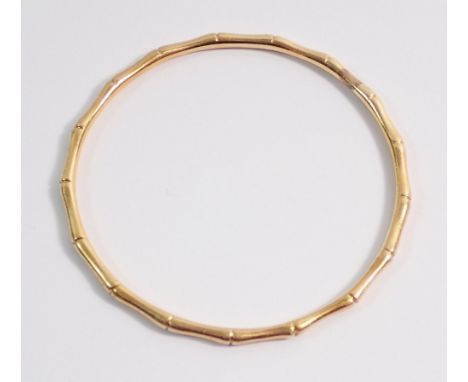 A gold bamboo effect child's bangle, unmarked but tested as 14ct gold, 13g, internal measurement 5.3cm