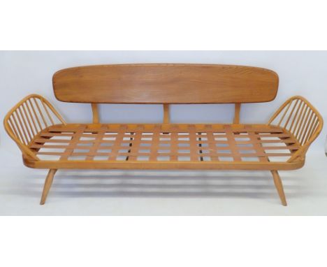 An Ercol elm and beech studio couch or day bed, No 355 (unfortunately the cushions supplied with this item do not have a fire