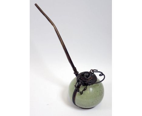An antique Louse green porcelain and metal opium pipe from Northern Laos, 15cm tall to top of pipe