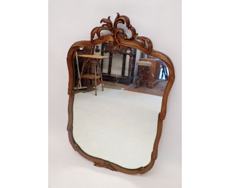 A vintage gold mirror with foliage decoration and ribbon/scroll design surround, 105cm high
