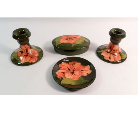 A pair of Moorcroft squat Hibiscus candlesticks - 9cm, trinket box and pin dish all on green ground