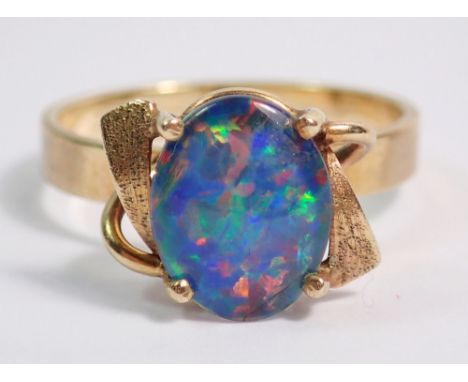 A 9 carat gold ring set opal doublet in scroll mount, size N, 3g