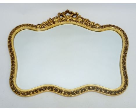 A vintage gilt framed mirror with ribbon and floral surmount, 87 x 72cm