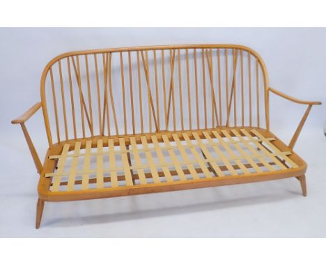 An Ercol stick back settee (unfortunately the cushions supplied with this item do not have a fire label and so cannot be sold