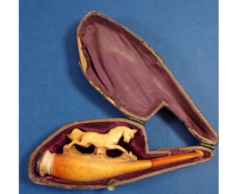 A 19th century meerschaum pipe carved with a horse jumping, with an amber mouthpiece, in fitted case, 12cm