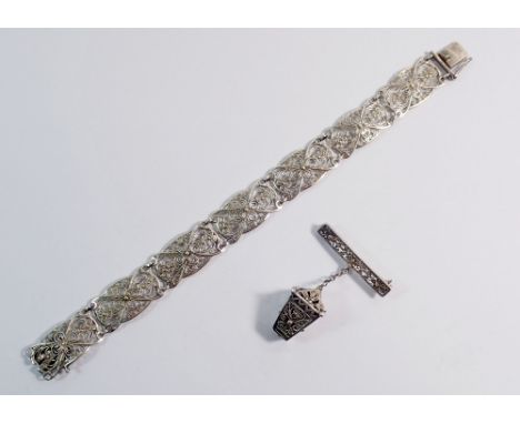 A 900 standard filigree lantern brooch and a white metal filigree bracelet 
