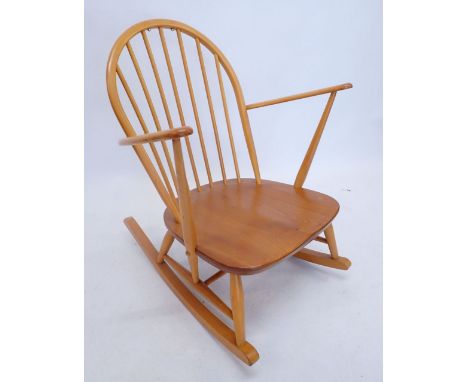 An Ercol elm seated stick back Windsor rocking chair (unfortunately the cushions supplied with this item do not have a fire l