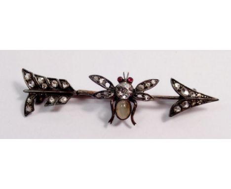 An antique silver arrow form brooch with bee set old cut diamonds, moonstone body and ruby eyes, 5.5cm long,&nbsp; a/f, with 