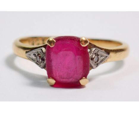 An 18 carat gold ruby ring on diamond chip shoulders, size L, 2.5g