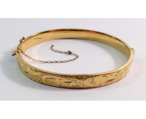 A 9 carat gold on metal core hinged bangle, total weight 10.3g