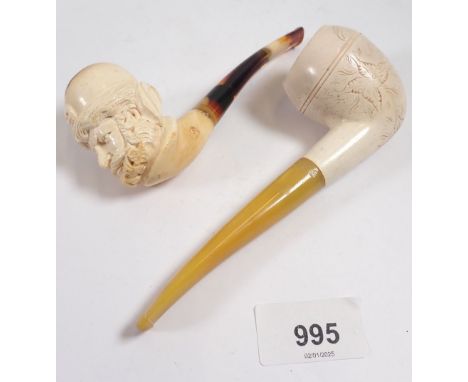 A 19th century meerschaum pipe carved in the form of a mans head, 12.5cm and another with engraved decoration