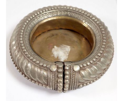 A white metal slave bangle converted to an ashtray, 15cm diameter