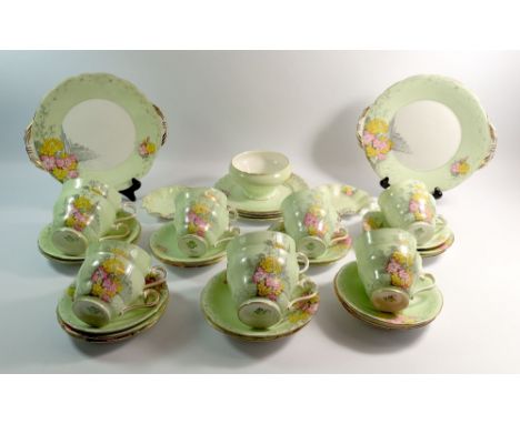 An Aynsley vintage green floral tea service comprising ten cups and fourteen saucers, four breakfast cups and saucers, four t