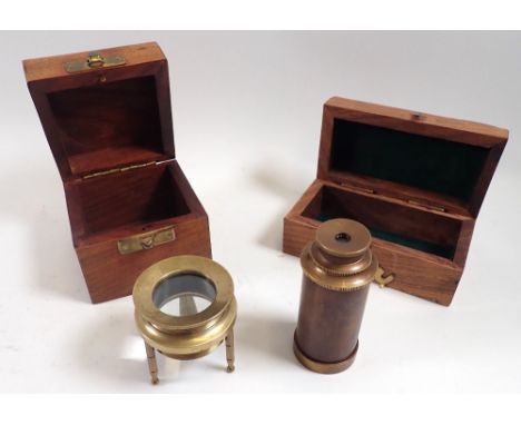 A brass and copper miniature reproduction pocket telescope and a brass magnifying lens, boxed