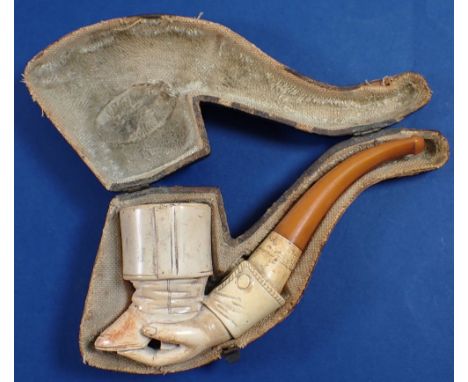 A 19th century meerschaum pipe carved in the form of a hand holding a boot, in fitted case, 15cm