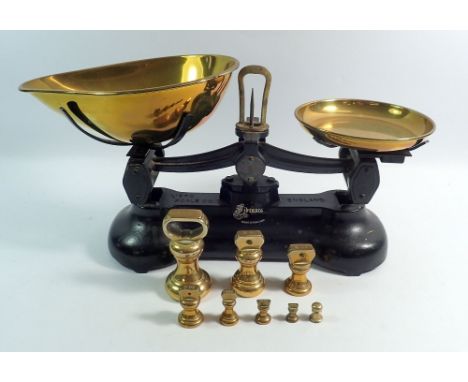 A pair of kitchen cast iron and brass scales and weights 
