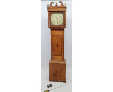 An 18th century longcase clock by Thomas Bates of Market Harboro with swan neck pediment over painted face, the oak case with