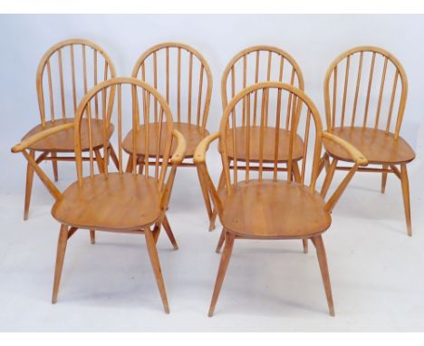 An Ercol matched set of eight stick back elm and beech Windsor dining chairs (four diners and two carvers) all with studs for