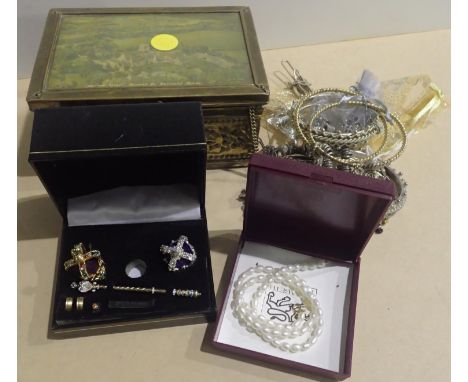 Lidded tin containing costume jewellery contents to include bangles, brooches, chains etc. 15 x 8 10 cm. P&amp;P Group 2 (£18