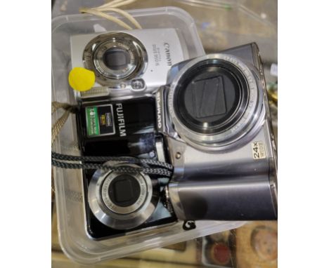 Fujifilm fourteen mega pixel digital camera with Olympus and Canon cameras. P&amp;P Group 1 (£14+VAT for the first lot and £1