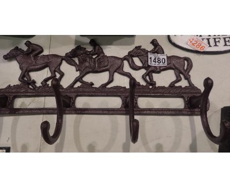 Cast iron horse and jockey coat rail, L: 40 cm. P&amp;P Group 2 (£18+VAT for the first lot and £3+VAT for subsequent lots) 