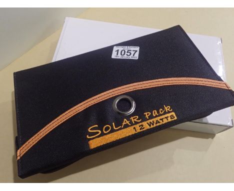 New old stock, 12 watt folding solar panel pack with two USB charging outputs. Integral part of case with magnetic catch and 
