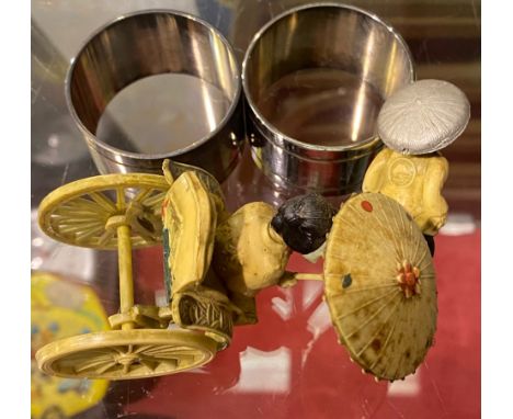 Lady in rickshaw and two white metal napkin rings. P&amp;P Group 1 (£14+VAT for the first lot and £1+VAT for subsequent lots)