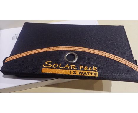 New old stock, 12 watt folding solar panel pack with two USB charging outputs. Integral part of case with magnetic catch and 