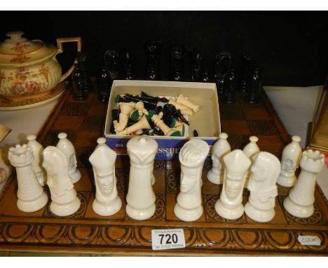 A chess set and other chess pieces.Pottery all in good condition. Smaller pieces not complete. Board is wooden.