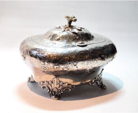 Silver tea caddy of oval, almost cushion shape, embossed with flowers and scrolls, on leafage and pad feet, by William Smily,