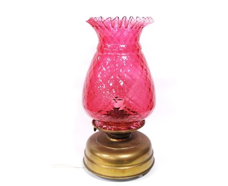 Brass lamp with a pineapple cranberry glass shade, 46cm high.&nbsp; &nbsp;CONDITION REPORT:&nbsp;Overall in good condition.&n
