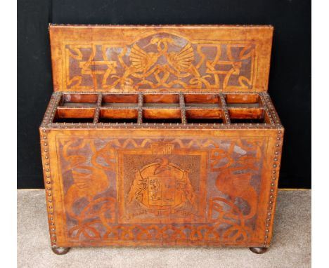 Tooled leather stick stand with armorial Fortis et Fidus, decorated with serpents and cranes, on bun feet, 82cm wide, 80cm hi