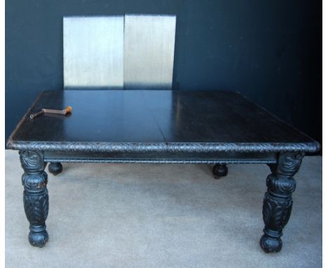 Victorian stained oak extending dining table, the carved rectangular top raised on foliate carved baluster legs terminating i