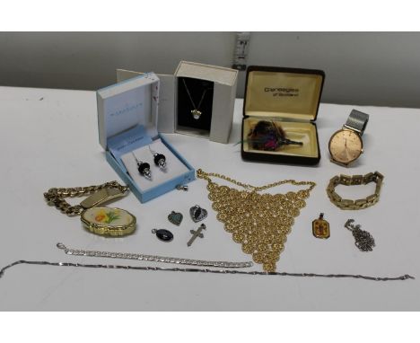 A shelf of assorted costume jewellery 