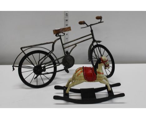 A metal bicycle model and vintage miniature wooden rocking horse 