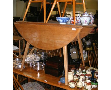 An Ercol "Golden Dawn" dining table with two chairs