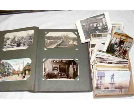 Selection of vintage postcards in an album and loose